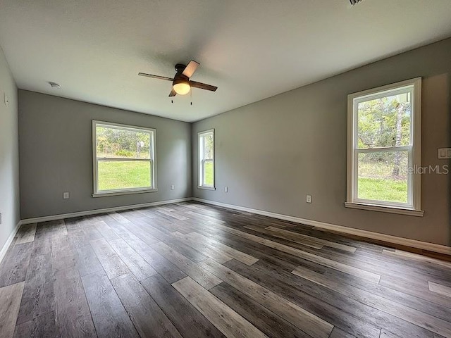 empty room featuring dark hardwood / wood-style flooring and ceiling fan