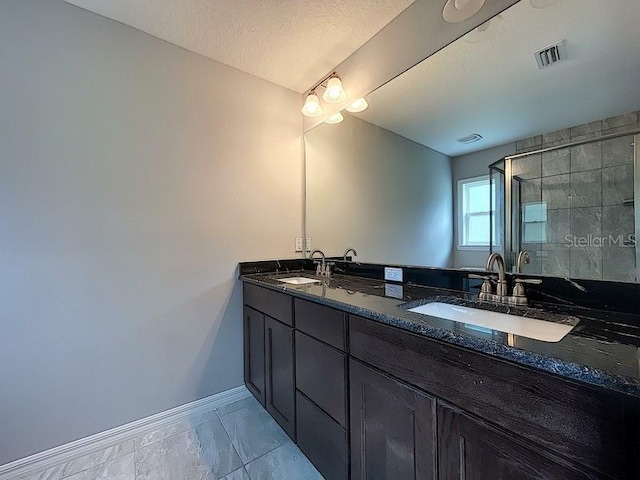 bathroom featuring vanity and a textured ceiling