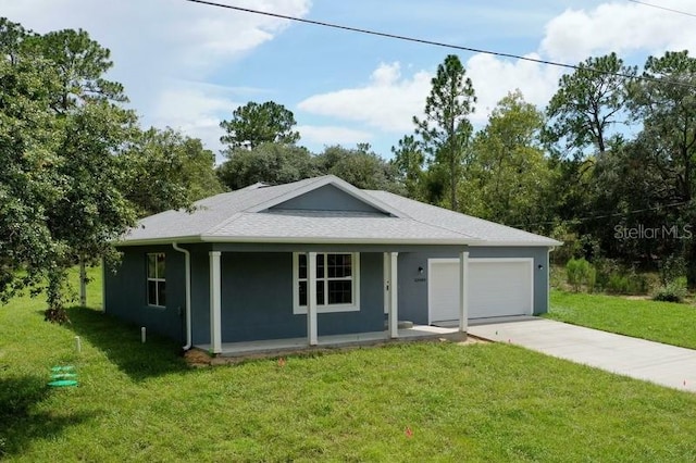 view of front of home featuring a garage, a front yard, and covered porch