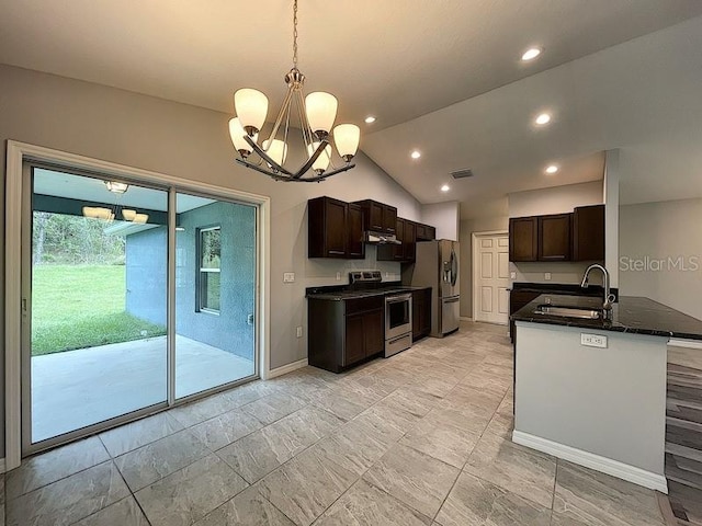 kitchen with sink, decorative light fixtures, vaulted ceiling, appliances with stainless steel finishes, and kitchen peninsula