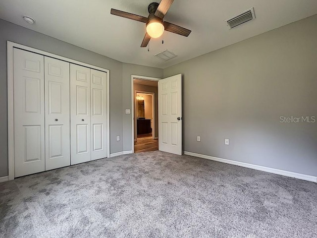 unfurnished bedroom featuring carpet flooring, ceiling fan, and a closet