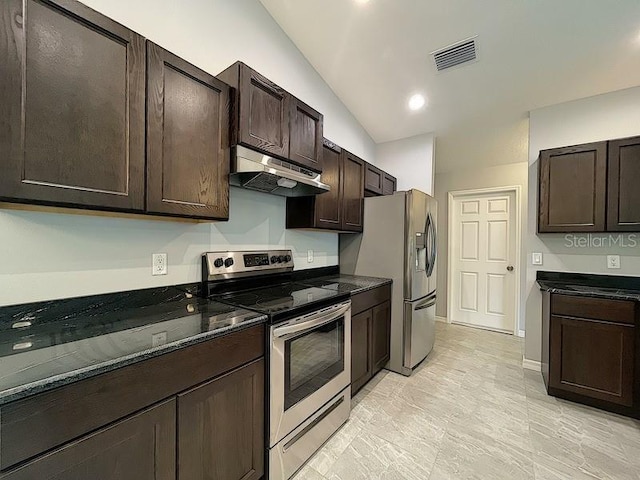 kitchen with dark brown cabinetry, vaulted ceiling, stainless steel appliances, and dark stone countertops