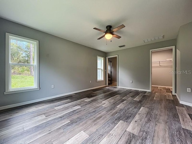 spare room with ceiling fan, a healthy amount of sunlight, and light wood-type flooring