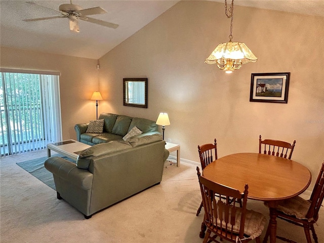 living room featuring ceiling fan with notable chandelier, light carpet, and lofted ceiling