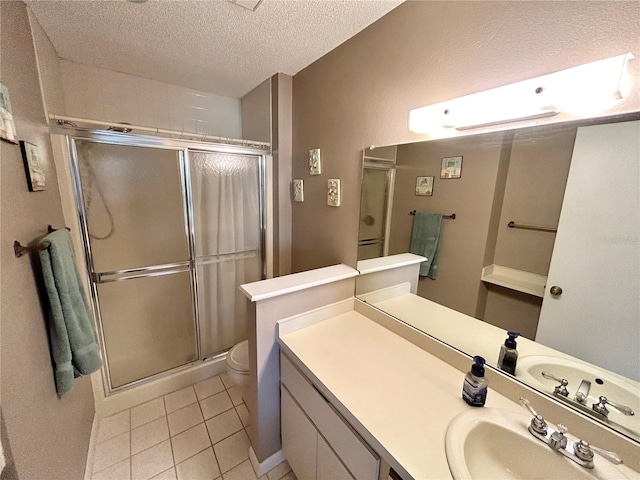 bathroom with a textured ceiling, an enclosed shower, tile floors, toilet, and vanity