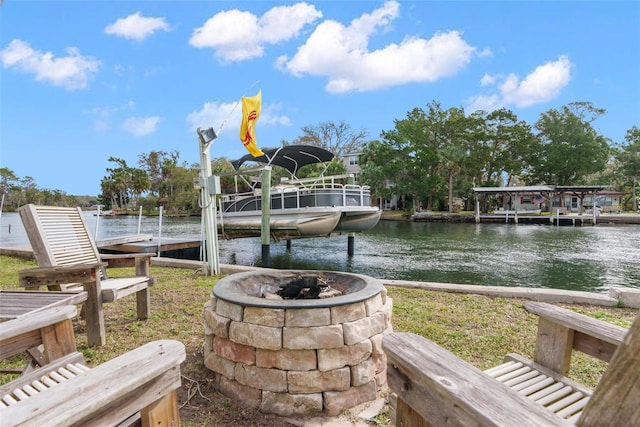 exterior space with a water view and a fire pit