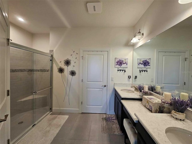 bathroom with tile patterned flooring, vanity, and a shower with shower door