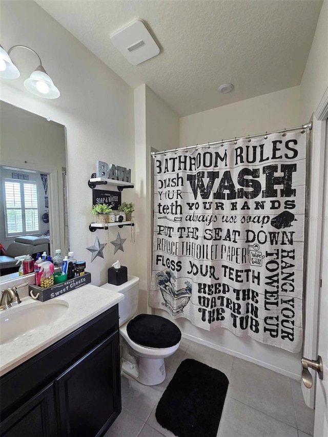 bathroom featuring tile patterned floors, shower / tub combo with curtain, toilet, a textured ceiling, and vanity