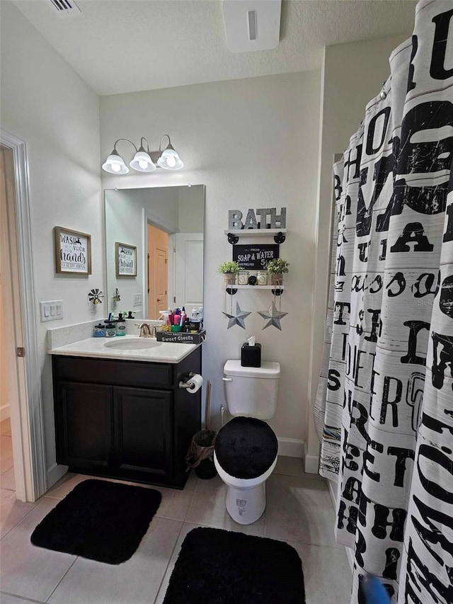 full bathroom with vanity, baseboards, a textured ceiling, tile patterned floors, and toilet