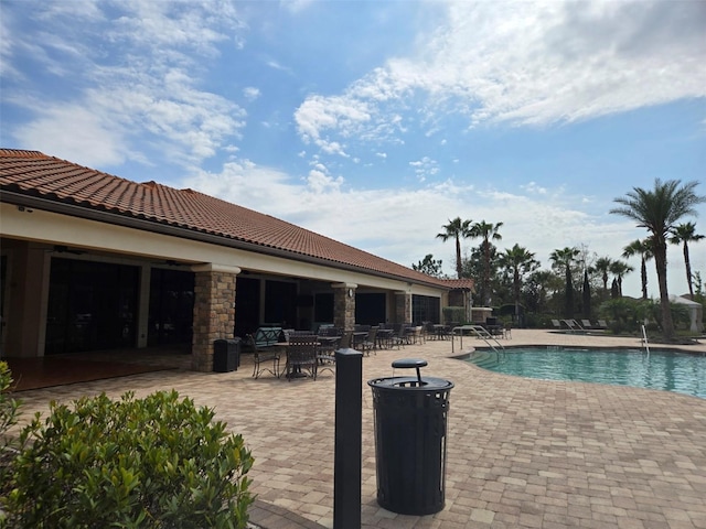 community pool with a patio area