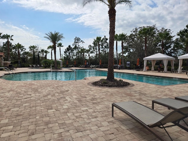 pool with a gazebo and a patio