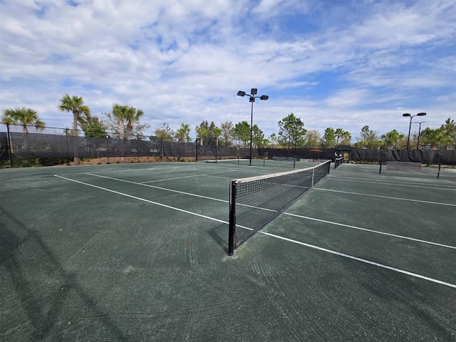 view of tennis court with fence