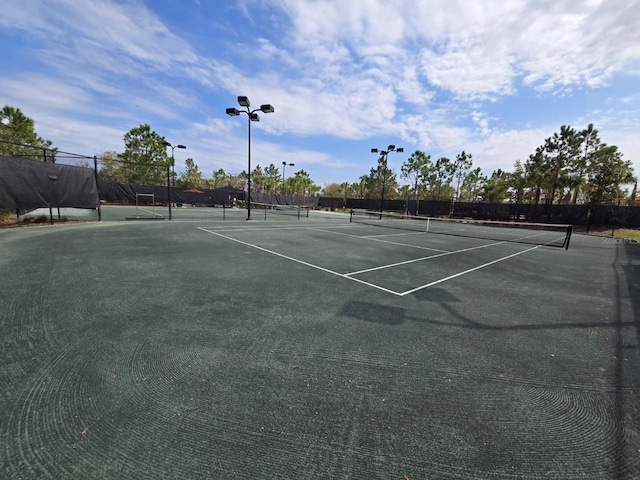 view of sport court featuring fence