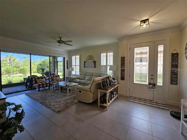 tiled living area featuring baseboards, a ceiling fan, and crown molding