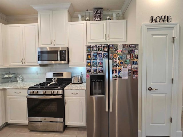 kitchen featuring tasteful backsplash, white cabinetry, and stainless steel appliances