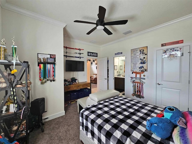 bedroom featuring ensuite bath, visible vents, dark carpet, and ornamental molding