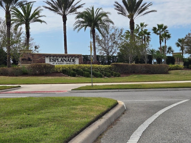 community / neighborhood sign with a lawn