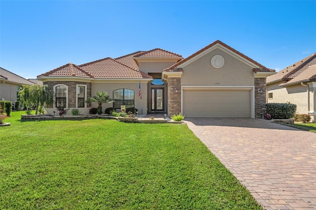 mediterranean / spanish house with a garage and a front yard