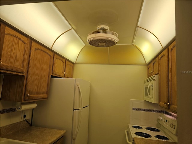 kitchen with white appliances and backsplash