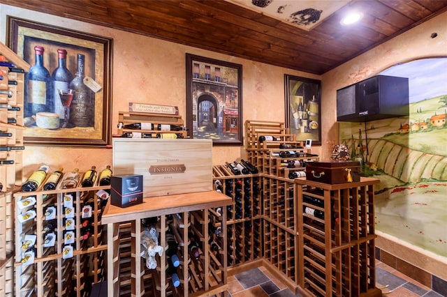 wine room with wooden ceiling and dark tile floors