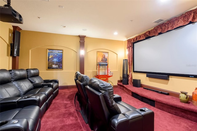 carpeted cinema room featuring decorative columns