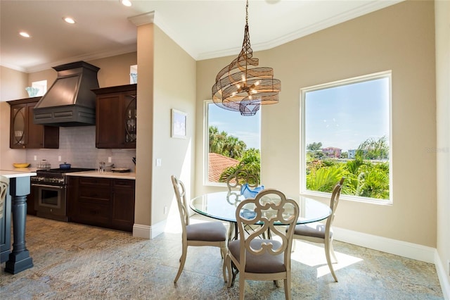 dining area featuring ornamental molding and a chandelier