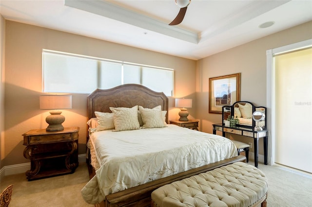 bedroom featuring a tray ceiling, ceiling fan, and light colored carpet