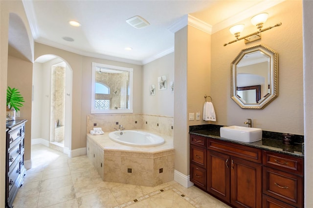 bathroom with double vanity, tile floors, crown molding, and tiled bath