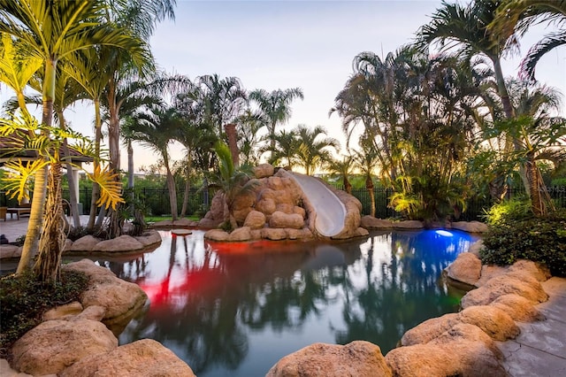 view of pool at dusk