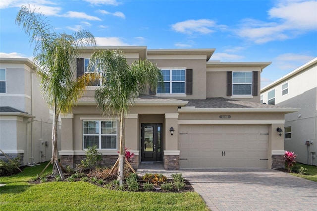 view of front of home with a front yard and a garage