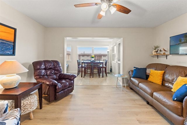 living room featuring light hardwood / wood-style flooring and ceiling fan