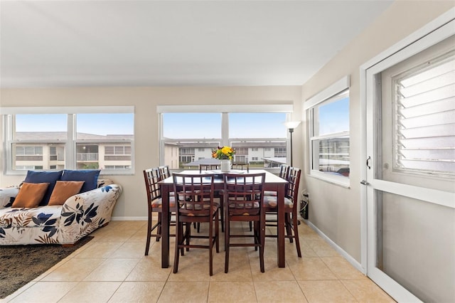 tiled dining space featuring plenty of natural light