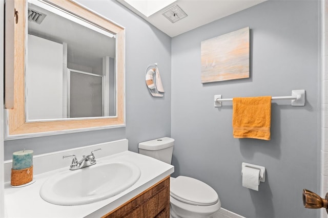 bathroom with walk in shower, vanity, and toilet