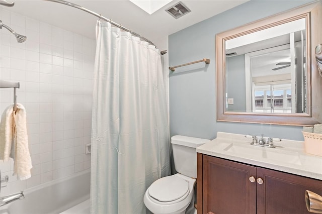 full bathroom with vanity, shower / tub combo, and toilet