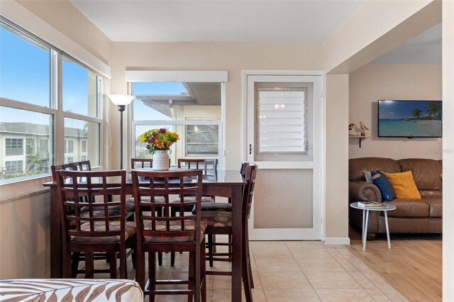 dining space with light tile patterned floors and a wealth of natural light