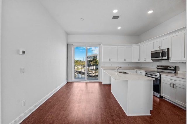 kitchen featuring white cabinets, dark hardwood / wood-style flooring, a kitchen island with sink, and stainless steel appliances