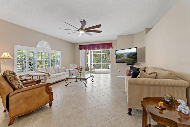 tiled living room featuring ceiling fan and a textured ceiling