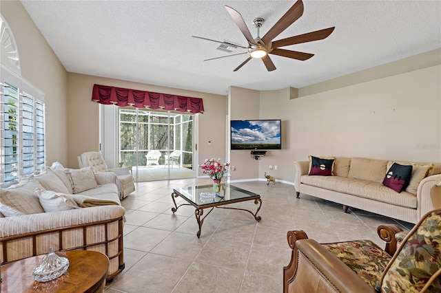 tiled living room with a textured ceiling and ceiling fan