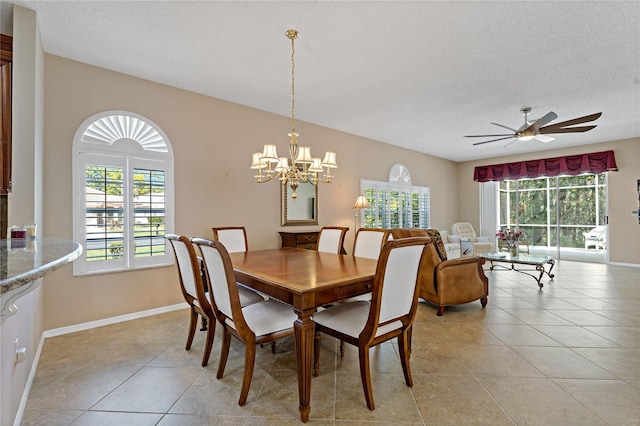 dining space featuring light tile flooring, a textured ceiling, and ceiling fan with notable chandelier