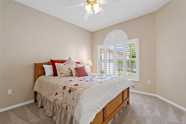 carpeted bedroom featuring a textured ceiling and ceiling fan