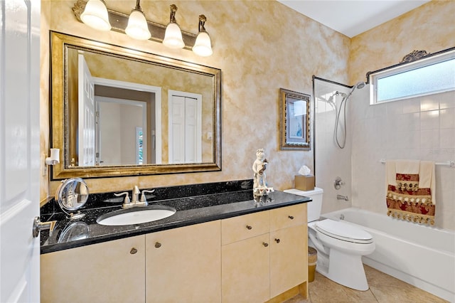 full bathroom featuring tile floors, tiled shower / bath, toilet, and vanity