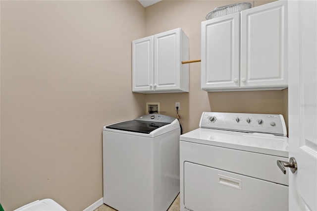 washroom with cabinets, hookup for a washing machine, and washing machine and clothes dryer