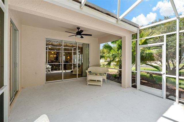 unfurnished sunroom with ceiling fan