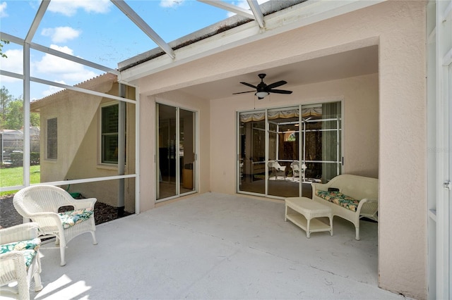 unfurnished sunroom featuring ceiling fan