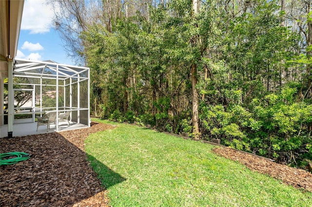 view of yard with a lanai and a patio