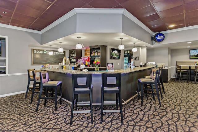 bar featuring hanging light fixtures, light stone countertops, ornamental molding, and carpet flooring