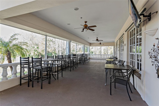 sunroom featuring ceiling fan