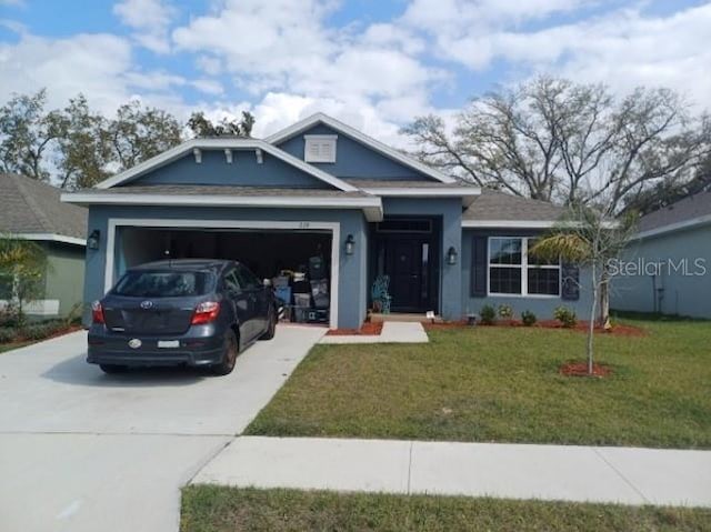 view of front of house with a front lawn and a garage