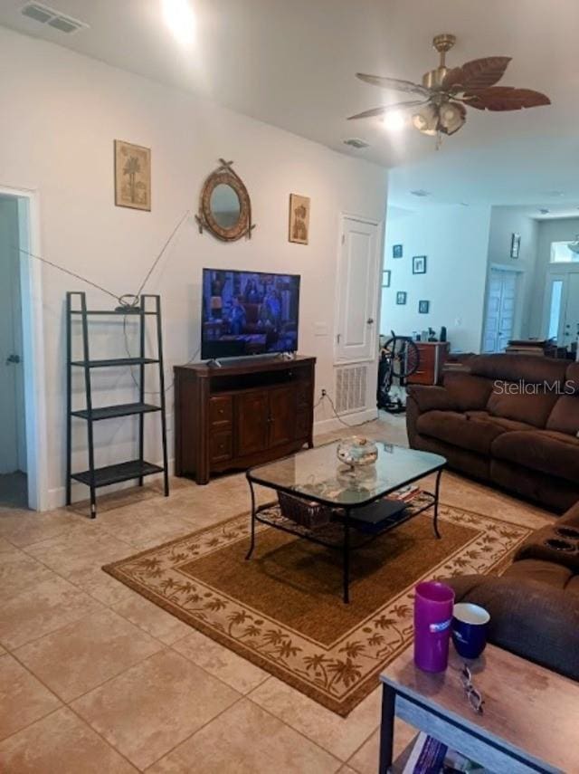 tiled living room featuring ceiling fan