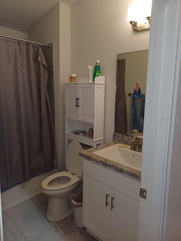 full bathroom with toilet, tile flooring, shower / bath combo, and vanity